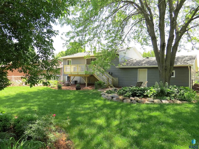 view of yard featuring a deck and stairs
