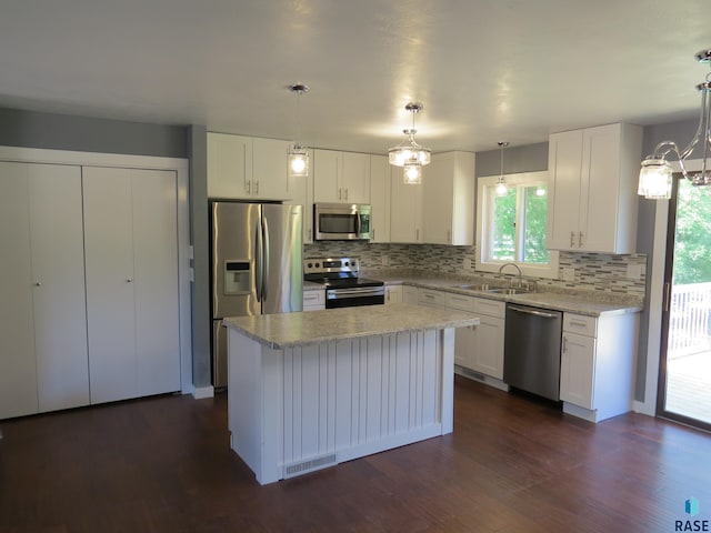 kitchen featuring a sink, tasteful backsplash, a notable chandelier, and stainless steel appliances
