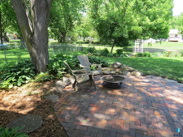 view of patio with fence and an outdoor fire pit