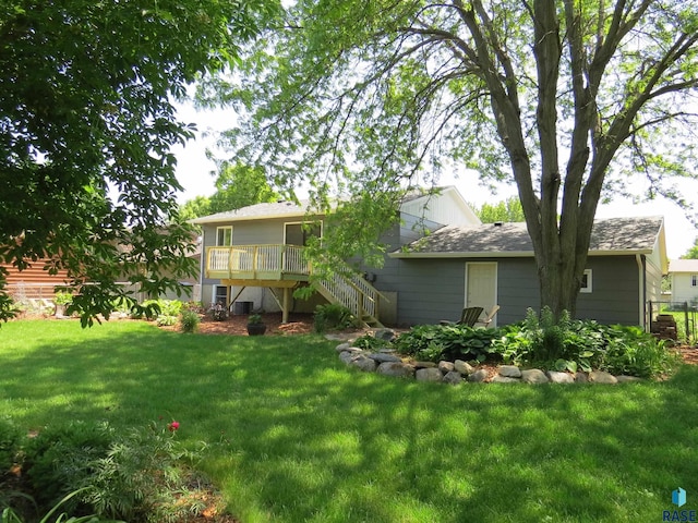 view of yard with a wooden deck and stairs
