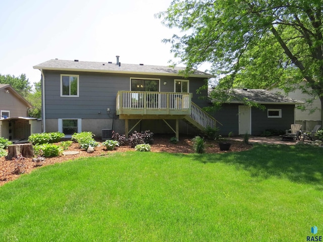 back of house featuring stairway, a yard, and a wooden deck