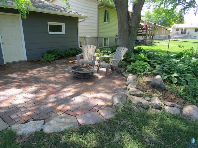 view of patio / terrace featuring an outdoor fire pit and fence