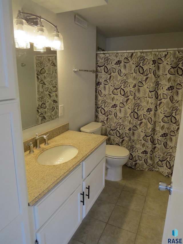 full bathroom featuring vanity, tile patterned flooring, toilet, and visible vents