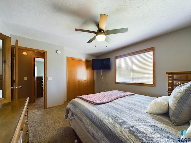 301 W Hackberry St, Brandon, SD 57005 - bedroom featuring a closet, carpet flooring, a textured ceiling, and a ceiling fan