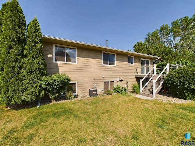 301 W Hackberry St, Brandon, SD 57005 - rear view of property featuring a lawn, a wooden deck, stairs, and central AC unit