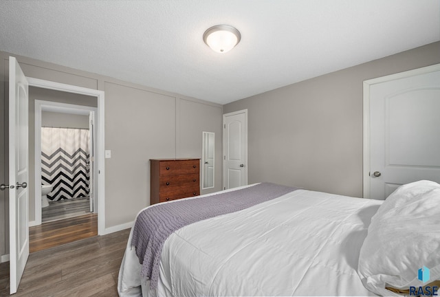 bedroom featuring baseboards and wood finished floors
