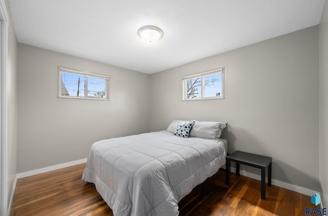 bedroom with baseboards and wood finished floors