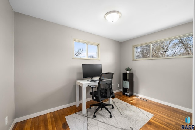 office with plenty of natural light, baseboards, and wood finished floors