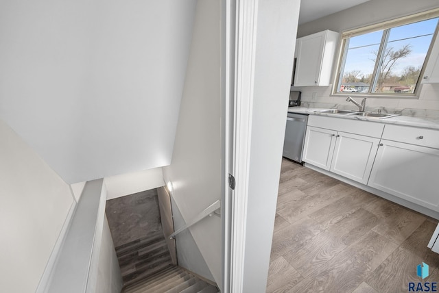 stairs featuring wood finished floors