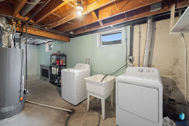below grade area featuring separate washer and dryer, a sink, and water heater