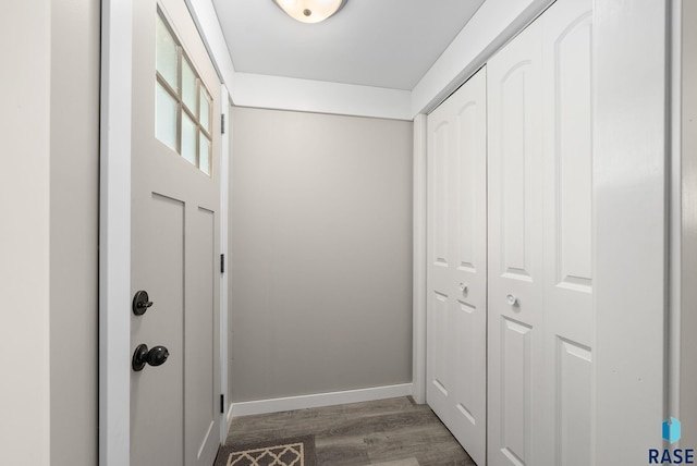 entryway featuring baseboards and wood finished floors