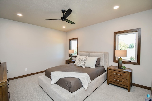 bedroom with baseboards, multiple windows, recessed lighting, and light colored carpet
