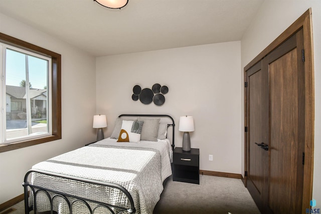 bedroom with baseboards and carpet flooring