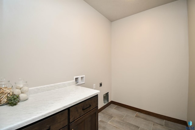laundry room featuring electric dryer hookup, hookup for a washing machine, cabinet space, and baseboards