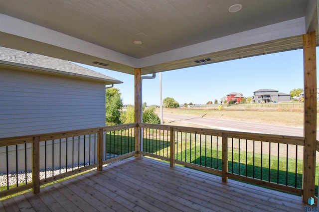 wooden deck featuring a yard