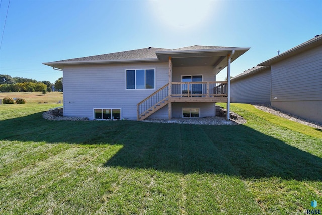 rear view of property featuring stairway, a yard, and a deck