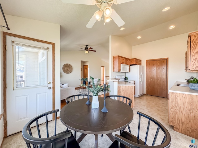 dining space with a ceiling fan, vaulted ceiling, and recessed lighting
