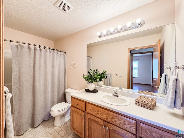 bathroom with vanity, toilet, a textured ceiling, a shower with shower curtain, and visible vents