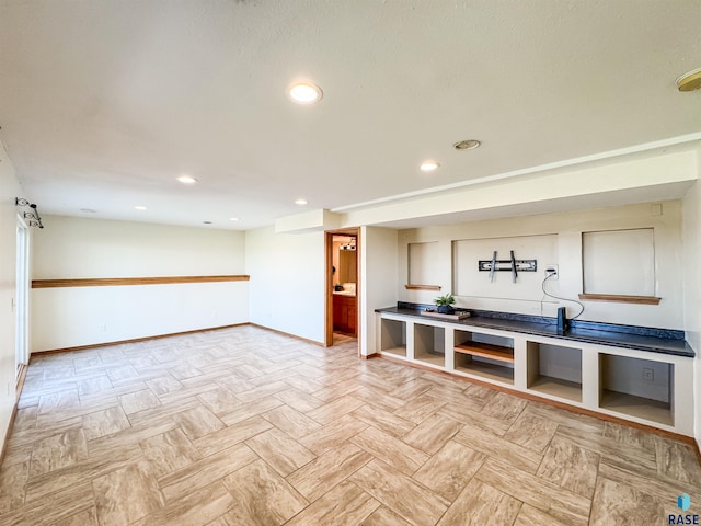 unfurnished living room featuring baseboards and recessed lighting