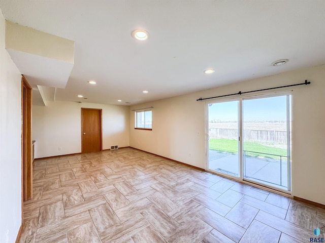 empty room featuring recessed lighting, baseboards, and visible vents