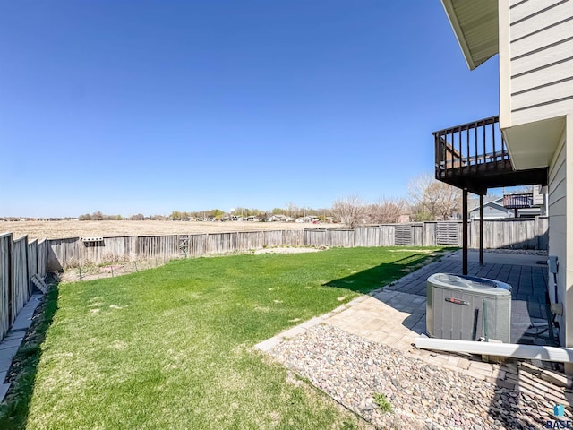 view of yard with a patio, a fenced backyard, and central air condition unit