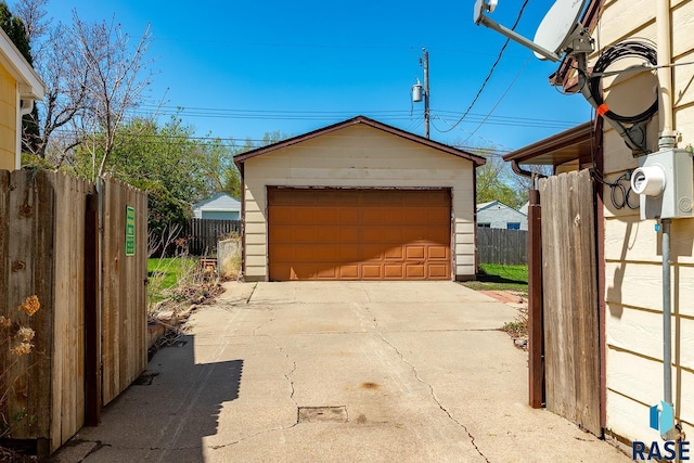 detached garage featuring fence