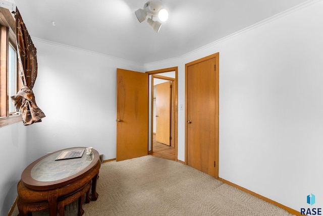 hallway featuring carpet flooring, baseboards, and ornamental molding