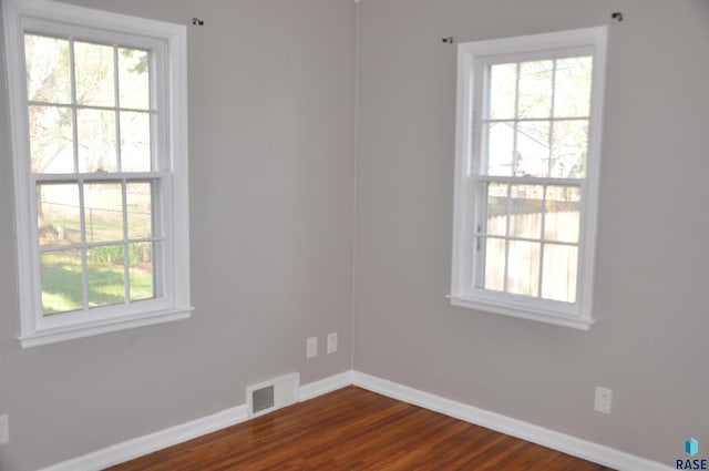 2911 S Norton Ave, Sioux Falls, SD 57105 - empty room with visible vents, baseboards, and dark wood-style floors