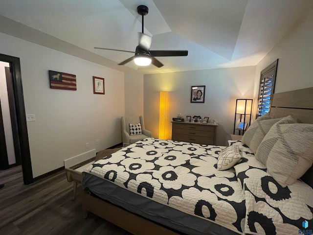 bedroom featuring baseboards, a ceiling fan, lofted ceiling, and wood finished floors