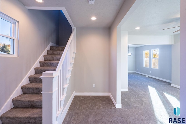 stairs with baseboards, carpet flooring, a textured ceiling, and recessed lighting