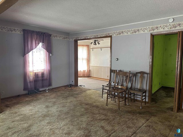 dining space with carpet floors and a textured ceiling