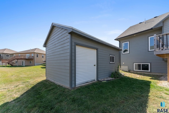 exterior space featuring a lawn and an outbuilding