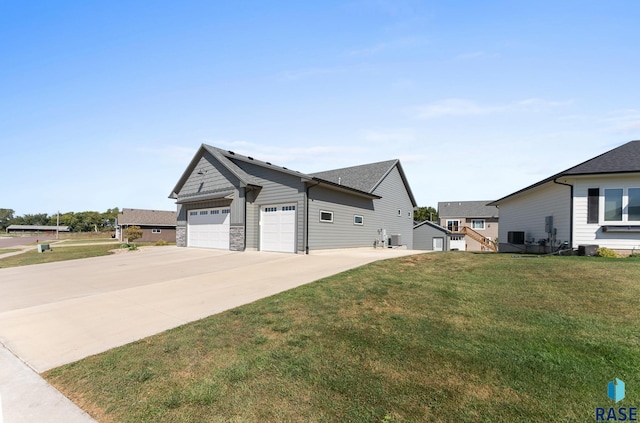 view of home's exterior with a shingled roof, an attached garage, a yard, and driveway