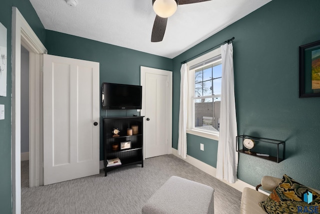 carpeted bedroom with baseboards and a ceiling fan
