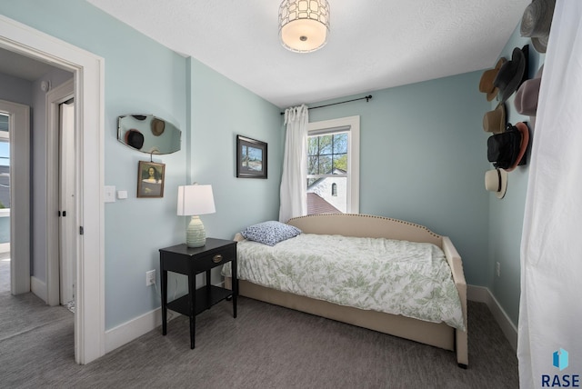 carpeted bedroom featuring baseboards