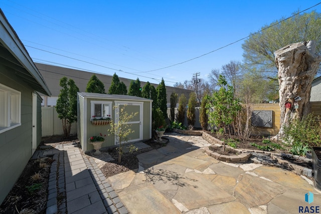 view of patio featuring a fenced backyard, an outbuilding, and a storage shed