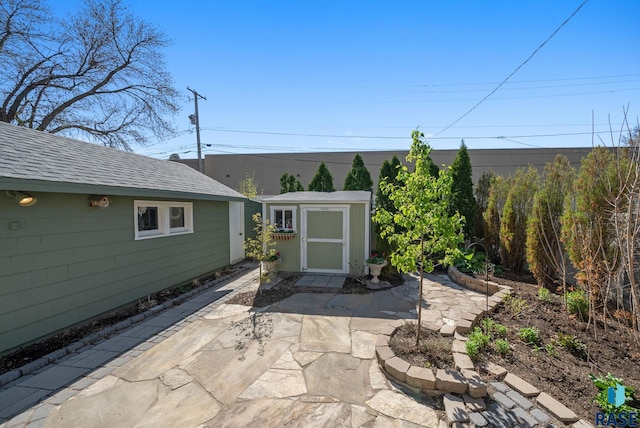 view of patio featuring a storage unit and an outdoor structure