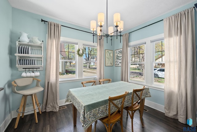 dining room featuring baseboards, dark wood-style floors, and an inviting chandelier