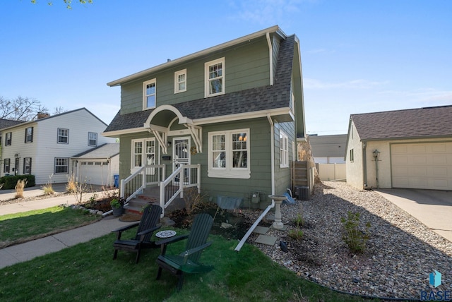 view of front facade with a garage, a front lawn, fence, roof with shingles, and driveway