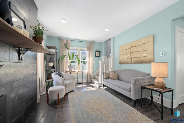 living room with recessed lighting, baseboards, stairs, and wood finished floors