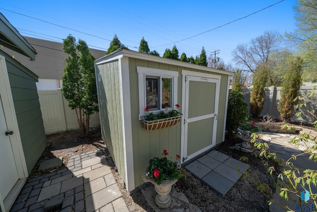 view of shed with a fenced backyard