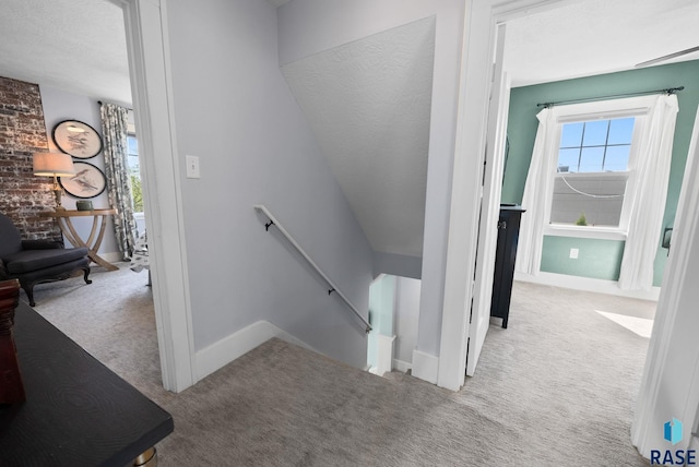 staircase with carpet floors and baseboards