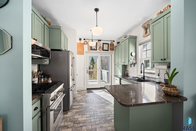 kitchen featuring a sink, green cabinetry, and stainless steel appliances