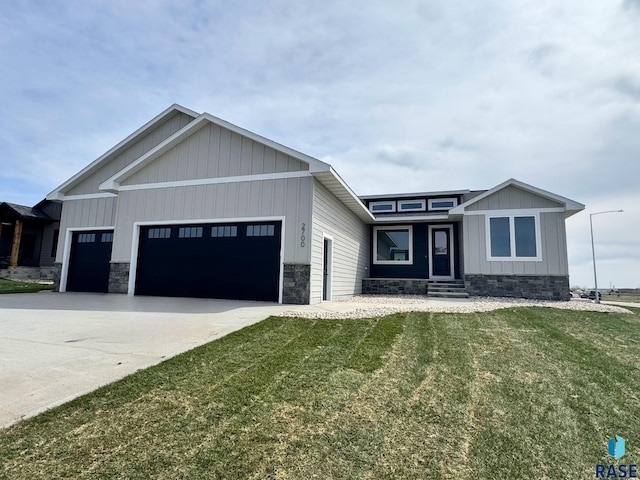2700 N Vermillion Cir, Tea, SD 57064 - view of front of home featuring a front yard, entry steps, concrete driveway, an attached garage, and stone siding