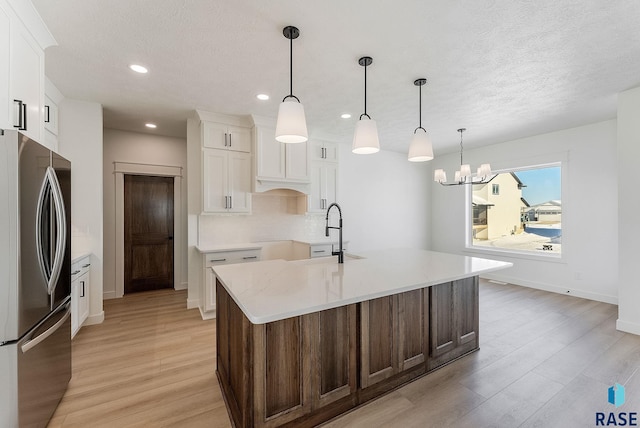 2700 N Vermillion Cir, Tea, SD 57064 - kitchen featuring freestanding refrigerator, decorative backsplash, recessed lighting, a sink, and light wood finished floors