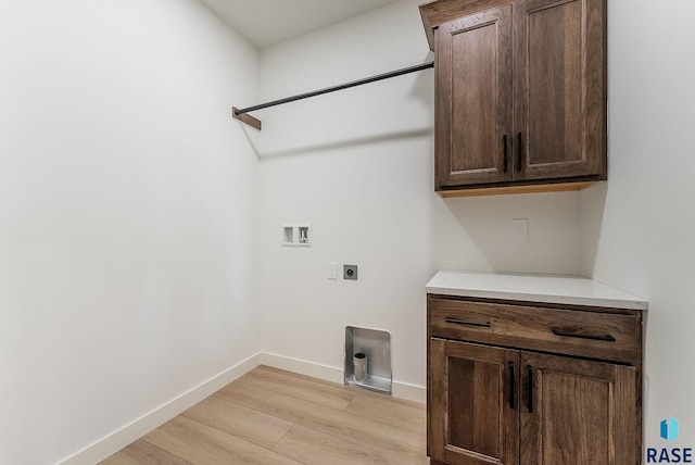 2700 N Vermillion Cir, Tea, SD 57064 - laundry area featuring washer hookup, electric dryer hookup, light wood-type flooring, cabinet space, and baseboards