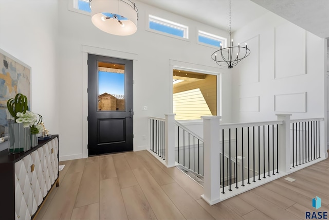 2700 N Vermillion Cir, Tea, SD 57064 - entryway featuring a high ceiling, light wood-type flooring, and a chandelier