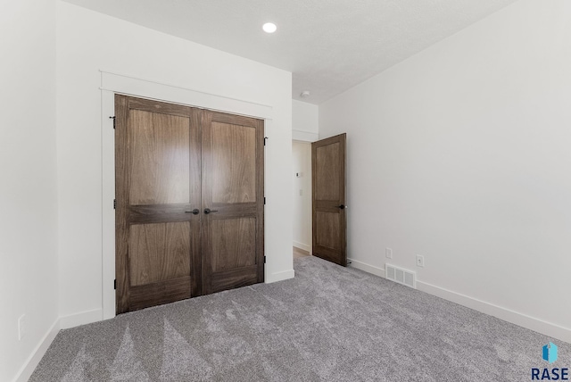 2700 N Vermillion Cir, Tea, SD 57064 - unfurnished bedroom with baseboards, carpet, a closet, and visible vents