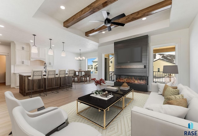 2700 N Vermillion Cir, Tea, SD 57064 - living room with light wood-style floors, recessed lighting, ceiling fan with notable chandelier, and a large fireplace