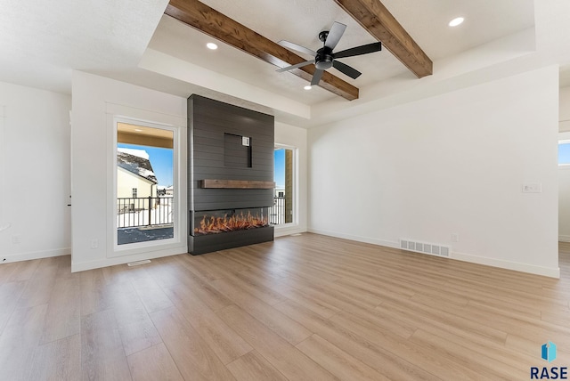 2700 N Vermillion Cir, Tea, SD 57064 - unfurnished living room with visible vents, plenty of natural light, and light wood finished floors
